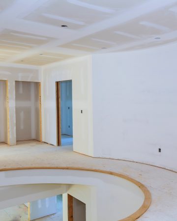 Walls of Interior construction of housing project with drywall installed and patched without